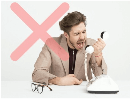 A man angrily shouting into an old-fashioned telephone receiver, with a large pink 'X' overlaying the image, indicating a negative or undesirable action.